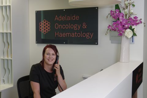 Jen Phone Sitting At Reception Desk