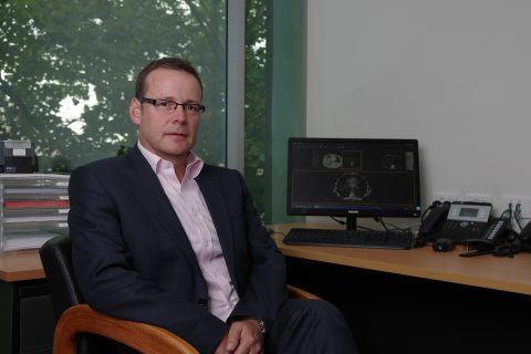 Ken Sitting At Desk